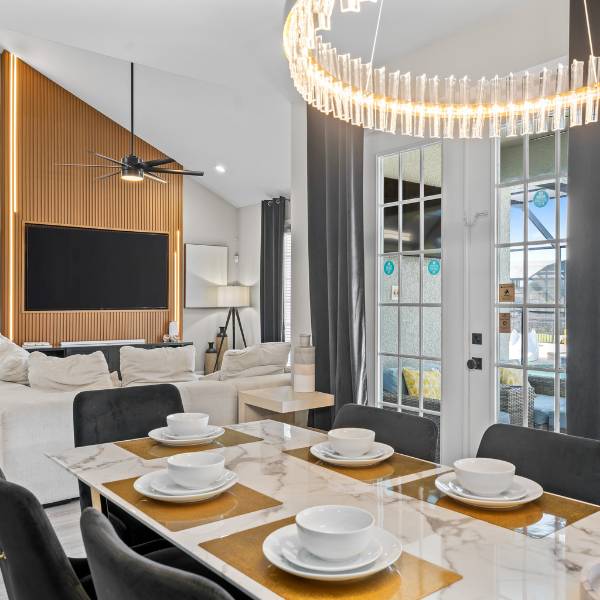 Luxury orlando vacation home dining table and living room for large group travel