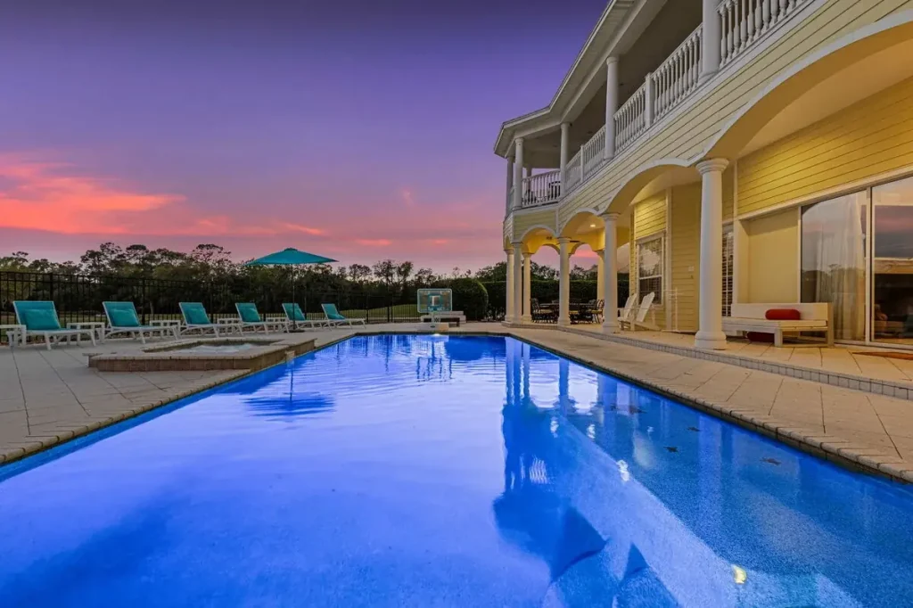 Twilight photo of private pool vacation home in reunion resort orlando florida